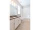 A clean bathroom, featuring a granite vanity, white cabinets, and a tub shower combo at 12312 Bay Estuary Bnd, Riverview, FL 33579