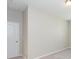 A bedroom with neutral walls, carpet flooring, and a single door at 12312 Bay Estuary Bnd, Riverview, FL 33579