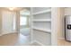 Open entryway with tile floors and built-in shelves at 12312 Bay Estuary Bnd, Riverview, FL 33579