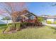 Landscaped front yard with mature trees and shrubs at 12312 Bay Estuary Bnd, Riverview, FL 33579