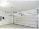 Two-car garage with an open garage door and epoxy floor at 12312 Bay Estuary Bnd, Riverview, FL 33579