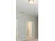 A hallway with neutral walls and doors leading to other rooms at 12312 Bay Estuary Bnd, Riverview, FL 33579