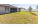 Back exterior of house showing a screened patio and yard at 12312 Bay Estuary Bnd, Riverview, FL 33579