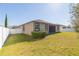 Back exterior view of a tan house with a screened patio at 12312 Bay Estuary Bnd, Riverview, FL 33579