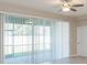 Living room with sliding glass doors and ceiling fan at 12312 Bay Estuary Bnd, Riverview, FL 33579