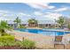 Community pool with lounge chairs and umbrellas at 12312 Bay Estuary Bnd, Riverview, FL 33579