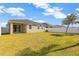 Large backyard with grassy lawn and home view at 13122 Satin Lily Dr, Riverview, FL 33579