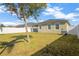 Landscaped backyard with lush lawn and tree at 13122 Satin Lily Dr, Riverview, FL 33579
