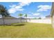 Fenced backyard with grassy lawn and palm trees at 13122 Satin Lily Dr, Riverview, FL 33579