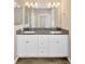 Double vanity bathroom with granite countertops and large mirror at 13122 Satin Lily Dr, Riverview, FL 33579