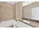 Bathroom with granite countertop, single vanity, and shower/tub combo at 13122 Satin Lily Dr, Riverview, FL 33579