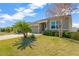 Landscaped front yard of a single-story house with a two-car garage at 13122 Satin Lily Dr, Riverview, FL 33579