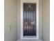 Modern dark-stained front door with a keypad lock at 13122 Satin Lily Dr, Riverview, FL 33579