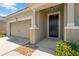 Black front door entryway with stone accents and landscaping at 13122 Satin Lily Dr, Riverview, FL 33579