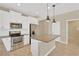 Modern kitchen with island, white cabinets, and stainless steel appliances at 13122 Satin Lily Dr, Riverview, FL 33579
