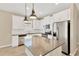 Modern kitchen with white cabinets, granite countertops and stainless steel appliances at 13122 Satin Lily Dr, Riverview, FL 33579