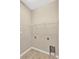 Bright laundry room with washer and dryer hookups, and ample shelving at 13122 Satin Lily Dr, Riverview, FL 33579