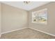 Bright and airy home office with large window and neutral decor at 13122 Satin Lily Dr, Riverview, FL 33579