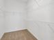 Large walk-in closet with wire shelving for hanging clothes and storage at 13122 Satin Lily Dr, Riverview, FL 33579