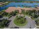Aerial view of community clubhouse, pool, and lake at 15724 Aurora Lake Cir, Wimauma, FL 33598