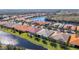 Community overview featuring a tranquil lake and numerous homes at 15724 Aurora Lake Cir, Wimauma, FL 33598