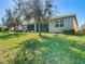 House with a screened patio and large grassy backyard at 15724 Aurora Lake Cir, Wimauma, FL 33598