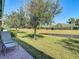 Serene backyard oasis with pond view and relaxing seating area at 15724 Aurora Lake Cir, Wimauma, FL 33598