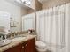 Bathroom with granite countertop, shower/tub combo, and updated vanity at 15724 Aurora Lake Cir, Wimauma, FL 33598