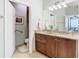 Well-lit bathroom with granite countertop, single sink, and adjacent toilet at 15724 Aurora Lake Cir, Wimauma, FL 33598