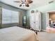 Guest bedroom with a queen-size bed, ceiling fan, and built-in wardrobe at 15724 Aurora Lake Cir, Wimauma, FL 33598