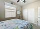 Bright bedroom with a white queen-size bed and ample closet space at 15724 Aurora Lake Cir, Wimauma, FL 33598