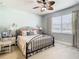 Main bedroom with a king-size bed, ceiling fan, and soft color palette at 15724 Aurora Lake Cir, Wimauma, FL 33598