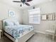 Charming bedroom with a white queen-size bed and unique mirror at 15724 Aurora Lake Cir, Wimauma, FL 33598