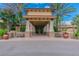 Community clubhouse entrance with stone accents and palm trees at 15724 Aurora Lake Cir, Wimauma, FL 33598