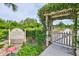 Entrance to community garden with arbor and rules at 15724 Aurora Lake Cir, Wimauma, FL 33598