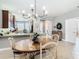 Bright dining area with chandelier and view into kitchen at 15724 Aurora Lake Cir, Wimauma, FL 33598
