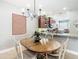Dining area with oval wooden table and white chairs at 15724 Aurora Lake Cir, Wimauma, FL 33598