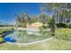 Impressive entrance to Valencia Lakes community with a pond feature at 15724 Aurora Lake Cir, Wimauma, FL 33598