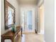 Bright and spacious entryway with a wooden console table and mirror at 15724 Aurora Lake Cir, Wimauma, FL 33598