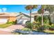 Single-story home with a two-car garage and landscaped front yard at 15724 Aurora Lake Cir, Wimauma, FL 33598