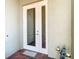 White front door with a glass panel and sidelights, adding curb appeal at 15724 Aurora Lake Cir, Wimauma, FL 33598