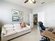 Spacious home office with a comfortable couch and open floor plan at 15724 Aurora Lake Cir, Wimauma, FL 33598