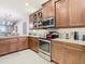 Kitchen features stainless steel appliances and granite countertops at 15724 Aurora Lake Cir, Wimauma, FL 33598