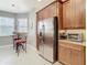 Stainless steel refrigerator and granite countertops in this kitchen at 15724 Aurora Lake Cir, Wimauma, FL 33598