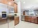 Stainless steel refrigerator and granite countertops in this kitchen at 15724 Aurora Lake Cir, Wimauma, FL 33598