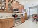 Modern kitchen with stainless steel appliances and ample wood cabinetry at 15724 Aurora Lake Cir, Wimauma, FL 33598