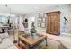 Spacious living room features a large glass-top coffee table and built-in wooden cabinet at 15724 Aurora Lake Cir, Wimauma, FL 33598