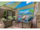 Relaxing outdoor patio with wicker furniture and shade sails at 15724 Aurora Lake Cir, Wimauma, FL 33598