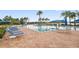 Community pool with patio furniture and lake views at 15724 Aurora Lake Cir, Wimauma, FL 33598