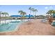 Relaxing pool area with lounge chairs and umbrellas at 15724 Aurora Lake Cir, Wimauma, FL 33598